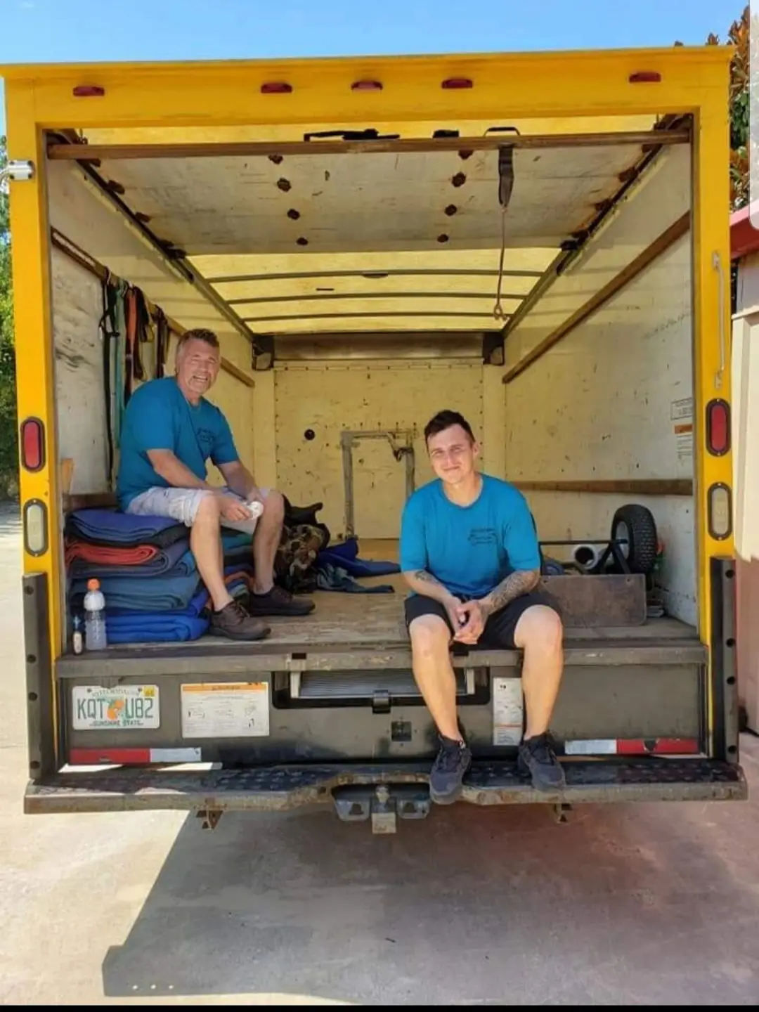 East Coast Moving crew members inside a loaded moving truck