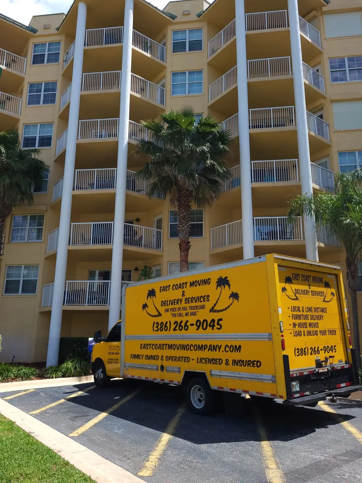 East Coast Moving truck outside a coastal condo building
